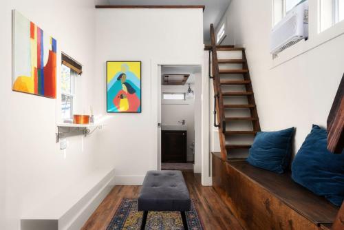 a living room with a couch and a stair case at Cozy Tiny Home on an Eco Farm Huge Yard in Austin