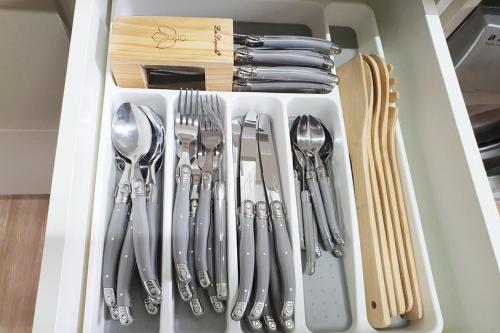 a drawer filled with silver utensils at Stylish House 8mins walk to Figtree Grove in Figtree