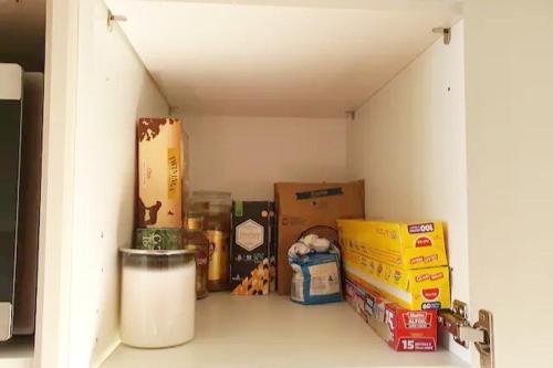 a small room with boxes and boxes of food at Stylish House 8mins walk to Figtree Grove in Figtree