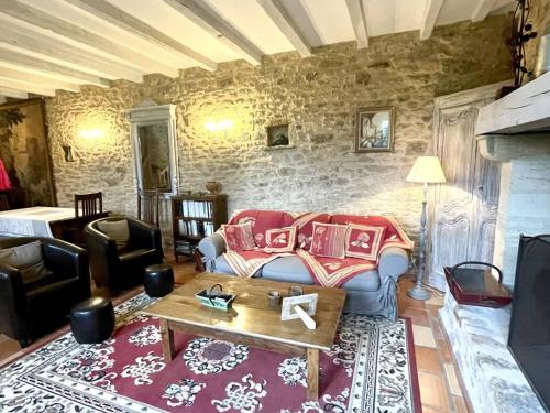 a living room with a couch and a table at Charmante demeure avec piscine privée pour 7 personnes - FR-1-824-3 in Saint-Chamassy
