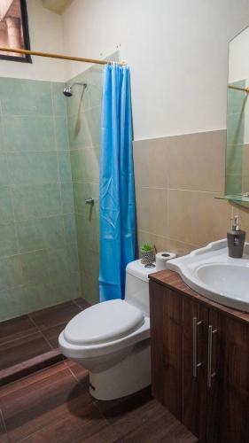 a bathroom with a toilet and a sink and a shower at Departamento completo, facso in Cuatro Hermanas