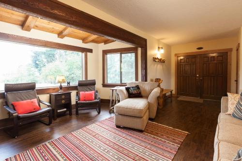 a living room with a couch and chairs and a window at Hood View 30 Day Minimum in Mount Hood