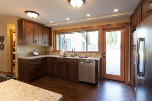 a kitchen with a sink and a refrigerator at Hood View 30 Day Minimum in Mount Hood