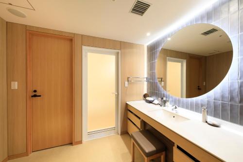 a bathroom with a sink and a mirror at Hakone Hisui in Hakone