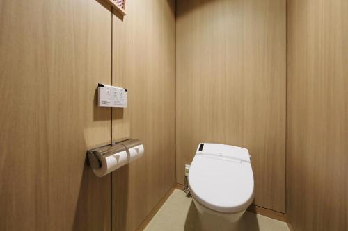 a bathroom with a white toilet in a stall at Hakone Hisui in Hakone