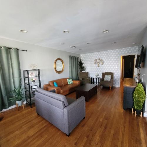 a living room with a couch and a table at 3 bedroom 2 bath home with Jacuzzi near Beverly Hills, wi-fi, Jacuzzi, Roku, BBQ, giant games family fun in Los Angeles