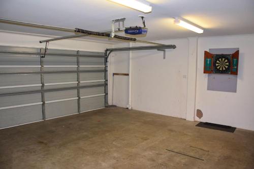an empty garage with a clock on the wall at Cool and Calm - Bring your own linen in South West Rocks