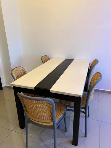 a dining room table with chairs around it at Lavender Villa Marc Residence Bukit Mertajam in Bukit Mertajam