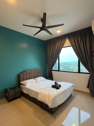 a bedroom with a bed with a ceiling fan at Lavender Villa Marc Residence Bukit Mertajam in Bukit Mertajam