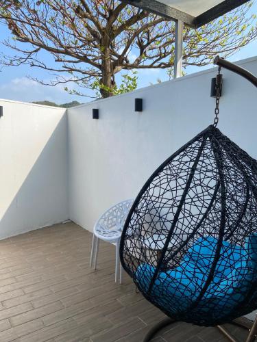 a net swing on a balcony with a tree at Okra Villa in Kenting