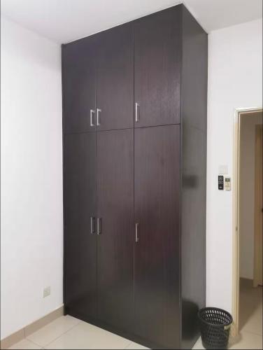 a large wooden cabinet in a room at Connaught Avenue in Kuala Lumpur