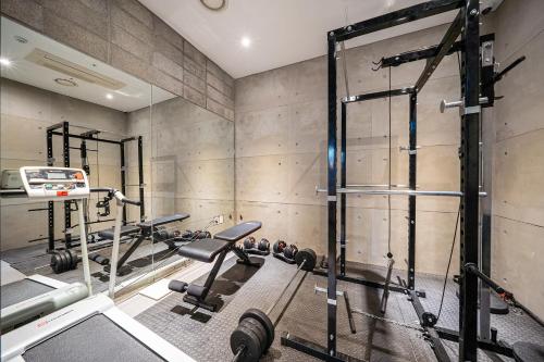 a gym with several tread machines and a mirror at Gong-Ju TouristHotel INK in Gongju