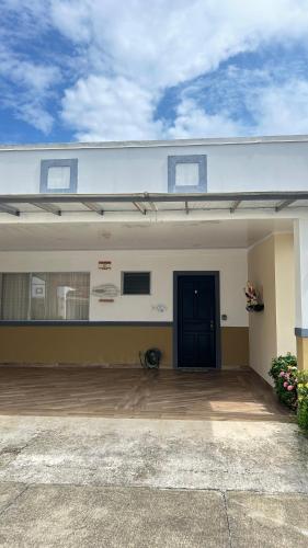 a garage with a black door on a house at Villa Lapas in Bejuco