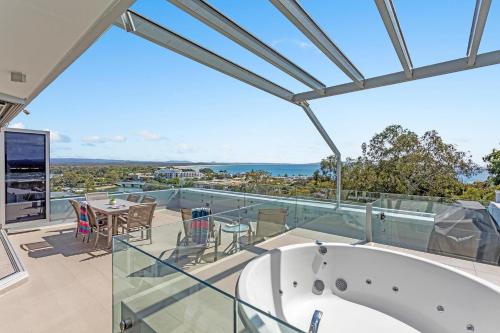 a tub on the balcony of a house at Picture Point Terraces in Noosa Heads