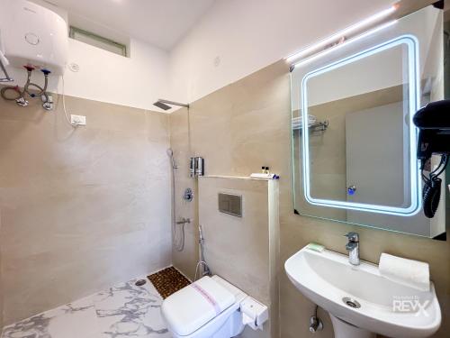 a bathroom with a sink and a mirror at The Neeraj River Forest Resort Ayurvedic Wellness Center in Rishīkesh