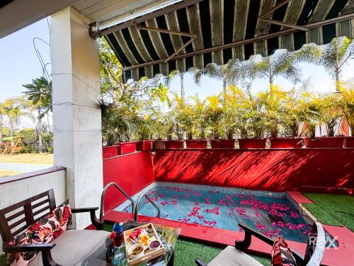 a small pool on a patio with two chairs at The Neeraj River Forest Resort Ayurvedic Wellness Center in Rishīkesh