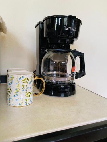 a coffee pot sitting on a counter next to a coffee mug at Casa Mi Puerto in Puerto Jiménez