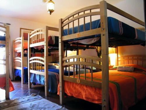 a room with three bunk beds in a room at Casa de los Santos in Guanajuato