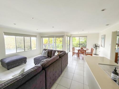 a living room with a couch and a table at Beach Break in Bargara