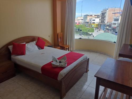 a bedroom with a bed with a bow on it at Royal Plaza Hotel Suite in Nueva Cajamarca