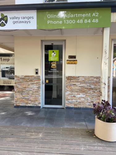 a entrance to a building with a glass door at Olinda Village Apartment - A2 in Olinda