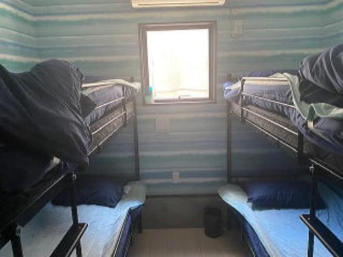 Ένα ή περισσότερα κρεβάτια σε δωμάτιο στο IRIE Fishing Experience Accommodation