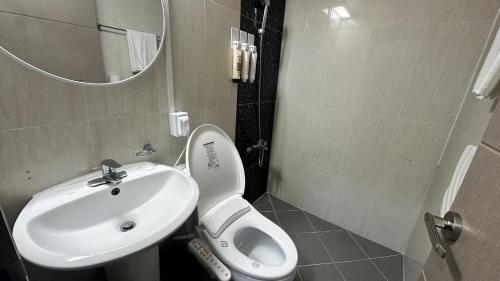 a bathroom with a white toilet and a sink at Hotel memory Jumunjin- Welcome drink provided in Gangneung