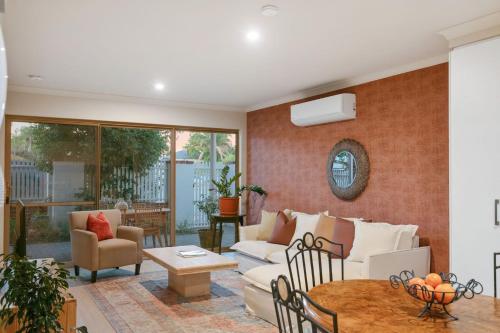 a living room with a couch and a table at Terra de Sol A Mediterranean Escape in Perth in Perth