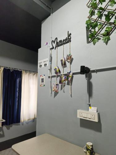 a room with hockey sticks hanging on a wall at Faith Dorms in Siliguri