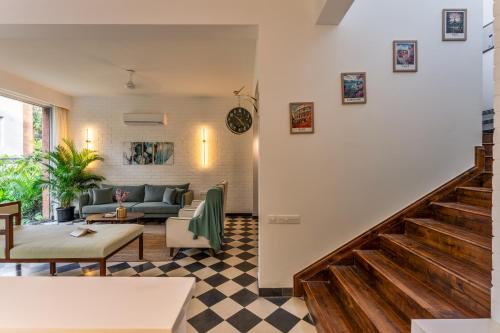 a living room with a couch and a table at La Verona - 2,3,4 BHK Villas in Assagao with Private Pool, Garden, Caretaker, Kitchen & Security in Assagao