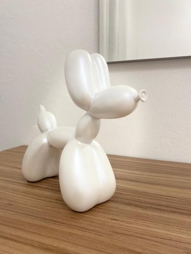 two white ceramic animals sitting on top of a table at Ca di nonni in Ortovero