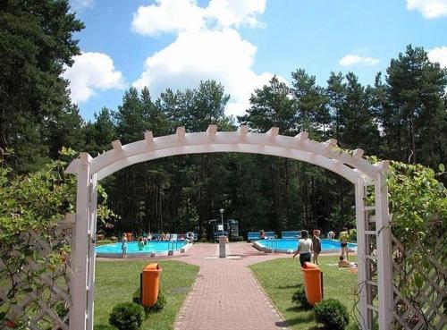 un arco en un parque con piscina en Centrum Szkolenia i Rekreacji Krasnobród, en Krasnobród
