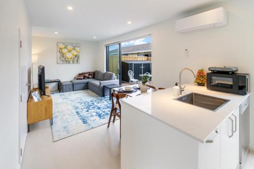 an open kitchen and living room with a couch at Affordable Comfort 2BR with Carpark in Christchurch