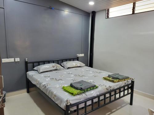 a bedroom with a bed with two towels on it at Datta Swami Homestay in Malvan