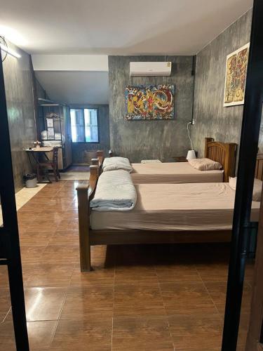 a bedroom with two beds in a room at The Bodhi House in Chiang Mai