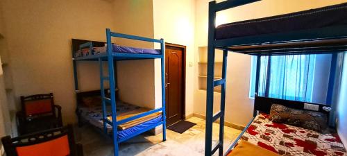 a room with two bunk beds and a bed at Sukha's Place in Pushkar