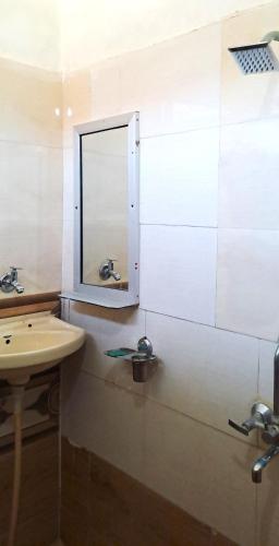 a bathroom with a sink and a mirror on the wall at Sukha's Place in Pushkar