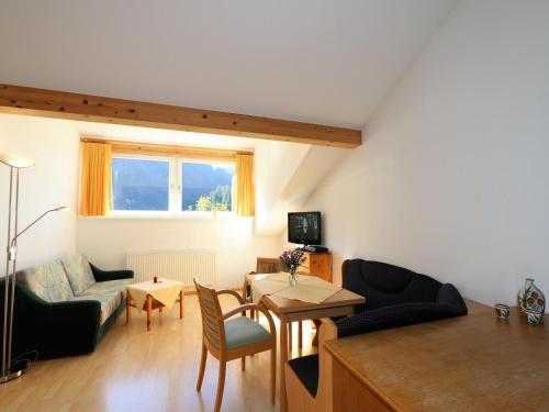 a living room with a couch and a table at Apartment in Zugspitz Arena near Cycle Path in Bichlbach