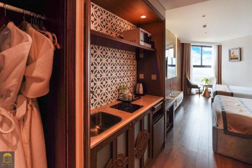 a kitchen with a counter and a sink in a room at Mandala Pearl Azure Retreat in Ấp Nhơn Long