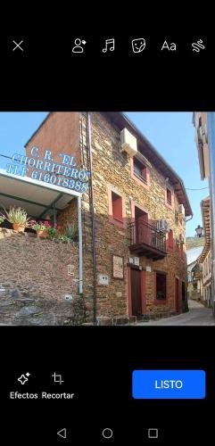 a screenshot of a building with a sign next to it at Casa Rural El Chorritero in Ovejuela
