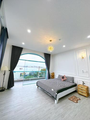 a bedroom with a bed and a large window at Xing Ocean Vũng Tàu in Vung Tau