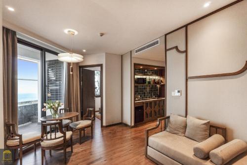 a living room with a couch and a table at Mandala Pearl Azure Retreat in Ấp Nhơn Long