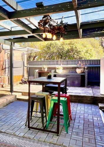 a table and some colorful chairs on a patio at KW Hacienda in Upper Sturt