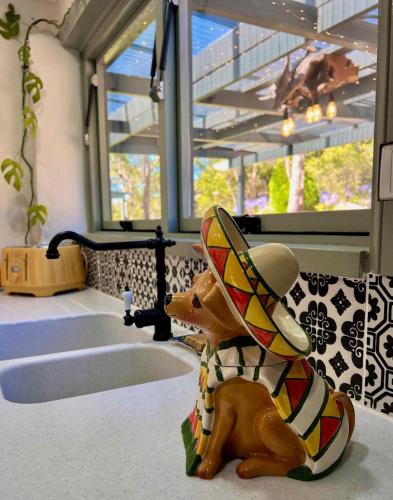 a toy dog wearing a hat in a bathroom at KW Hacienda in Upper Sturt