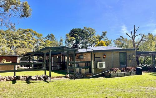 a house in a field with a grass yard at KW Hacienda in Upper Sturt