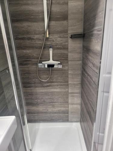 a bathroom with a shower with a toilet and a sink at Evabrite Homes in Dartford