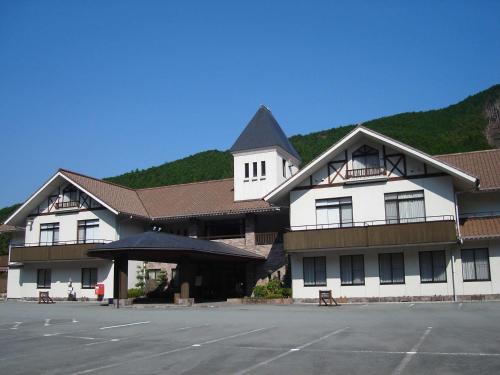 a large building with a parking lot in front of it at 奥伊勢フォレストピア in Ema