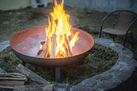 a fire in a pot with flames in it at プライベートリゾート富士 in Yamanakako