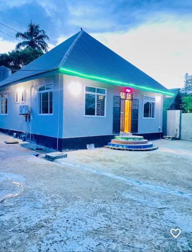 a small house with a neon sign on it at Triple A visitors in Kilindoni
