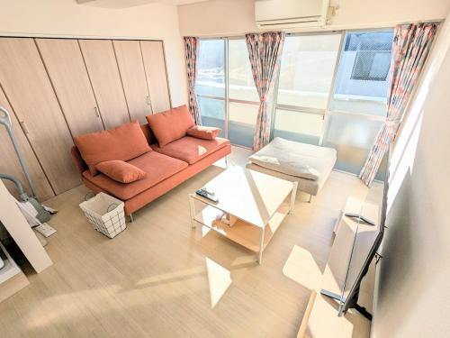 a living room with a couch and a table at Chateau Sunrise in Tokyo